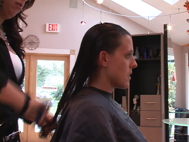 woman tells a hairdresser how she likes her hair cut