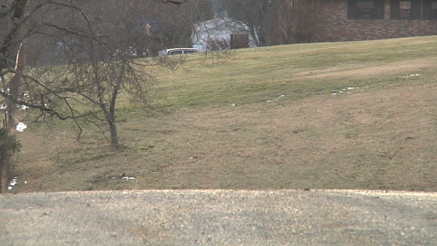 Man in bandanna with semi-automatic weapon approaches