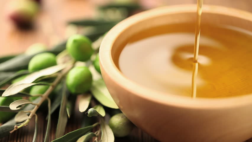 olive oil dripping on bowl