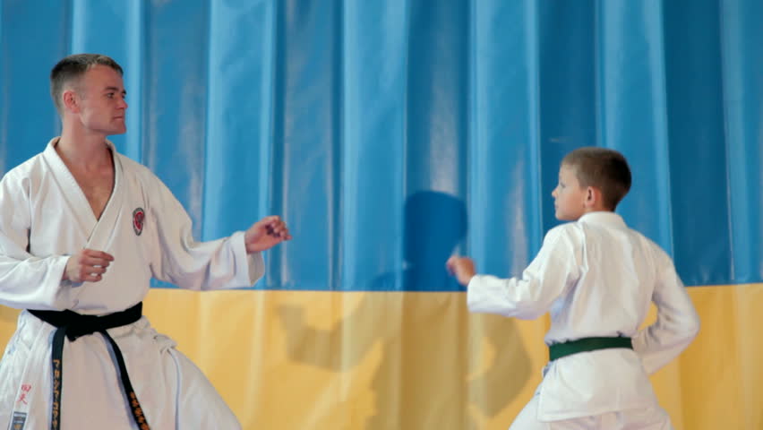 Boy learning from his karate instructor