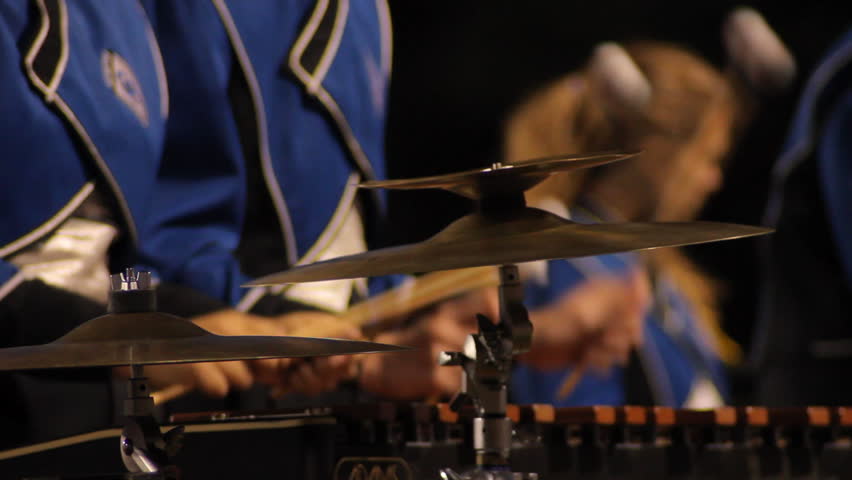 Close up of a marching band member playing the xylophone.