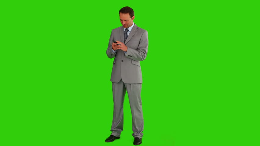 Chromakey footage of businessman in  a gray suit writing a text on his phone