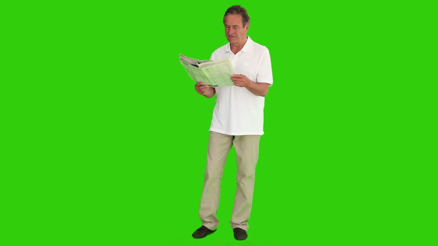 Chromakey footage of a senior man reading the newspaper