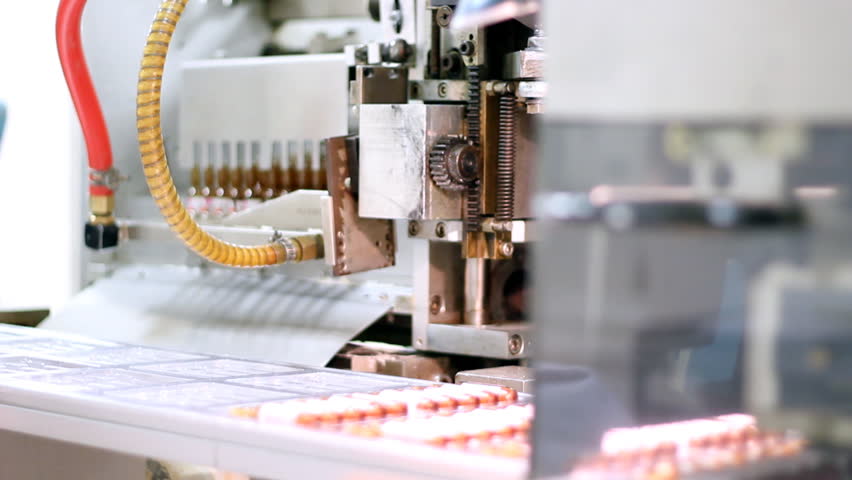Robotic arm lifting ampules in pharmaceutical factory.  HD 1080p.