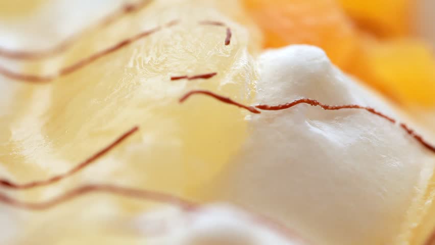 closeup of sweet ice-cream with fruit slices, rotate
