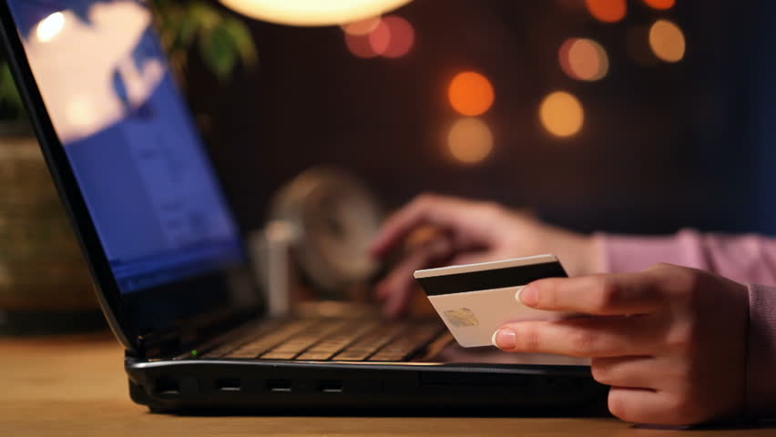 HD dolly: a girl using credit card online 