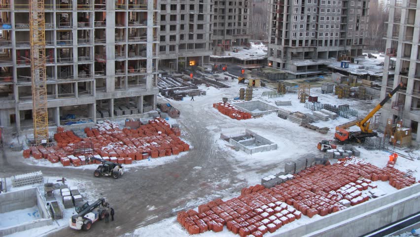Builders and machinery work in the evening, time lapse