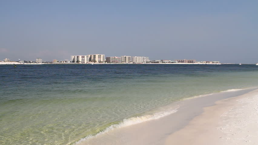 Viewed from across Destin Pass waterway, condominiums and resorts fill the skyline horizon of Destin, Florida's beach.