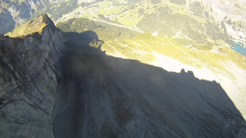 Frontal view of base jump down a cliff.