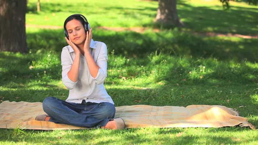 Cute woman taking a nap while listening to music with headphones
