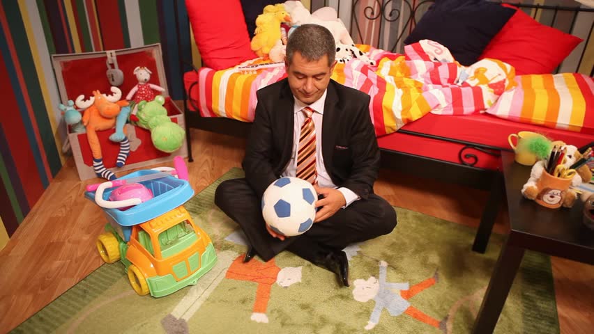 Mature man in full suit playing in children;s bedroom - Childish - Humor  