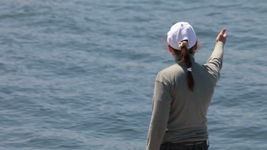 coach gives instructions while standing at the seashore