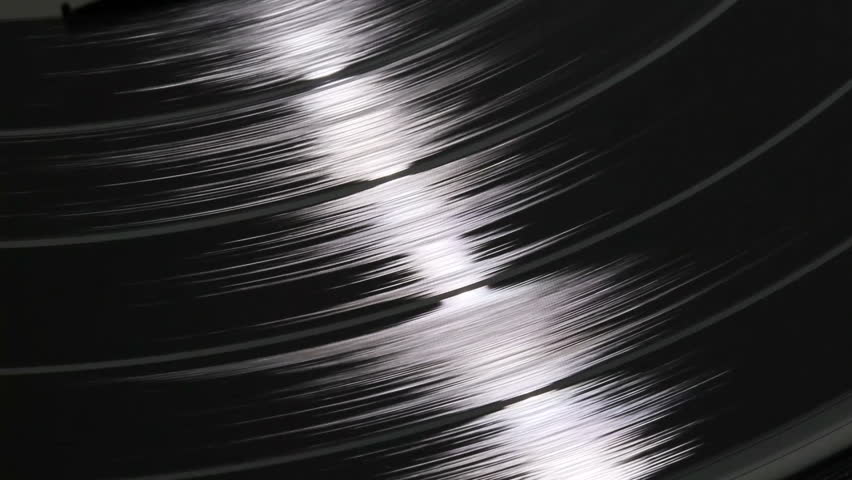 A spinning vinyl phonograph record close up 4 colors