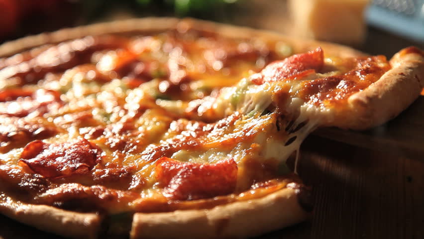 taking slice of pizza,melted cheese dripping