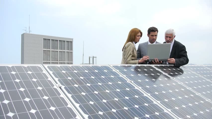 Business people standing by solar panels