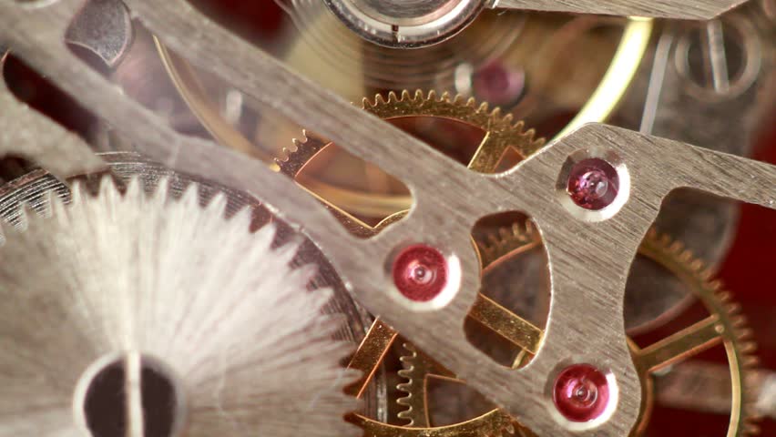 Moving metal gears inside working watch mechanism closer