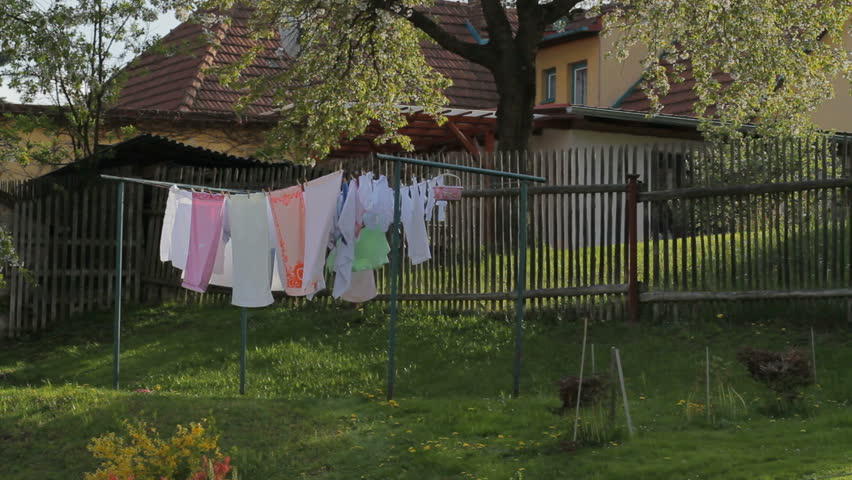 Washed clothes drying outside of an old house