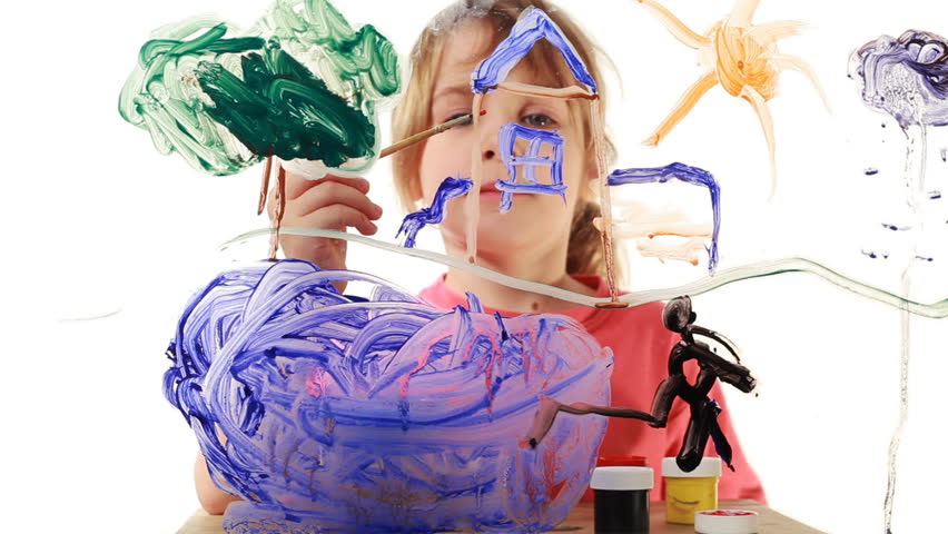 nice little girl begins to paint house wall in picture on transparent glass, behind white background