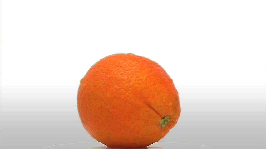 One orange (Naval variety) with water droplets on it. Isolated on a white background as it spins slowly in place.