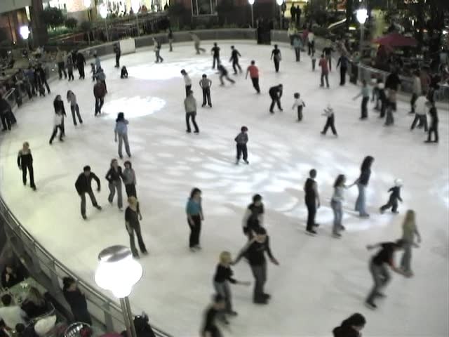 People skating on the rink in the mall