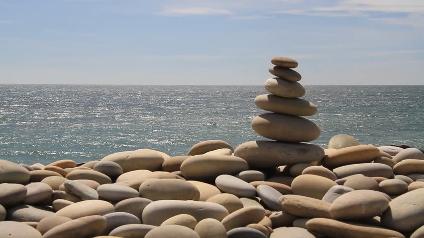 Pile of stones with sea and sky in background