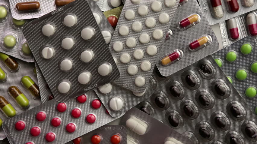 Hand grabbing many different pill blister packages (Full HD)