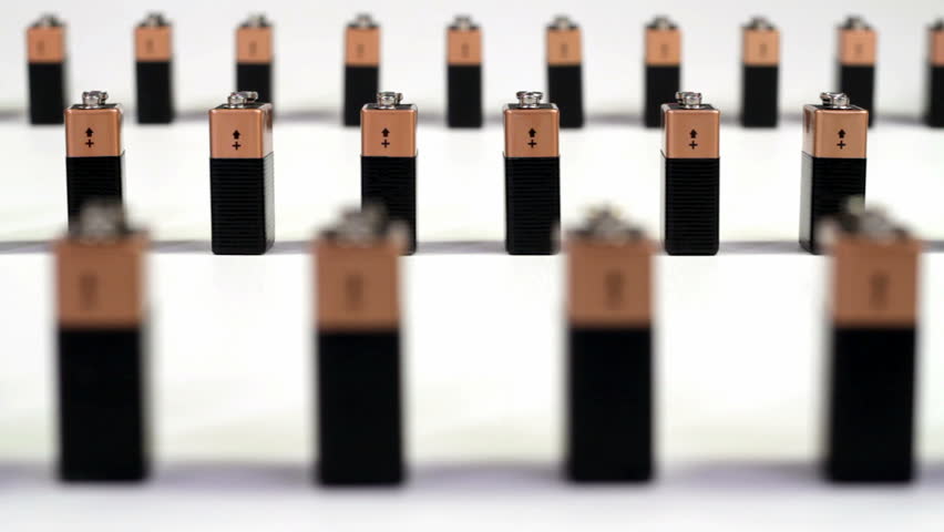 3 rows of 9-volt batteries falling like dominoes in alternating directions.  Focus is on middle section.
