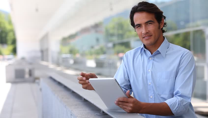 Handsome man using electronic tablet 