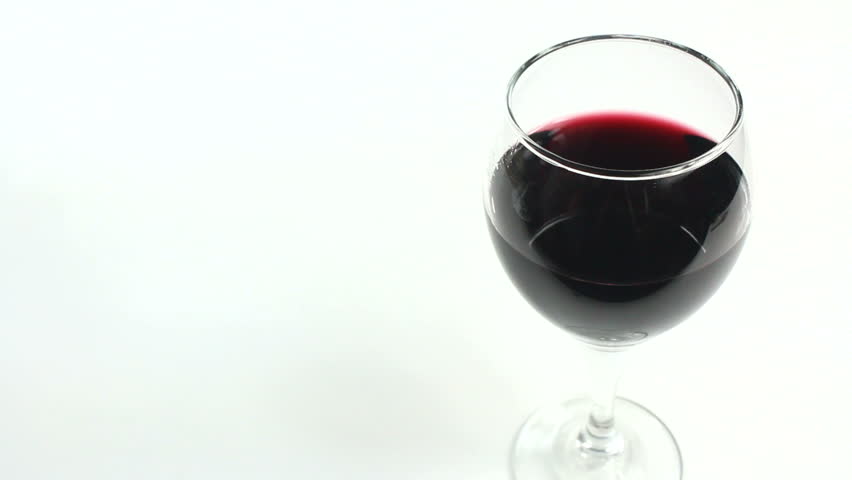 Man reaches for glass of wine, swirls it, observes color, texture, tastes it, places it back on the white background. 1080p
