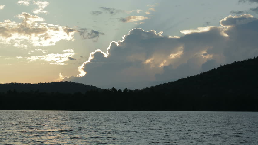 lake time-lapse of setting sun and incoming storm on Lows Lake Adirondack state park, NY,USA.