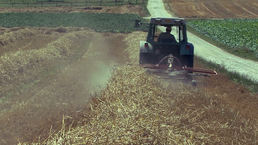 Farmer drives the tractor