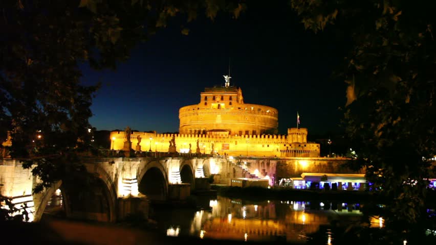 Sant Angelo Bridge side view and Sant Angelo Castel at night, river flow and cafe on quay are also shown