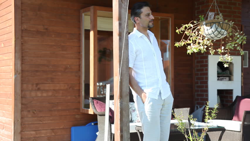man waiting in front of the house