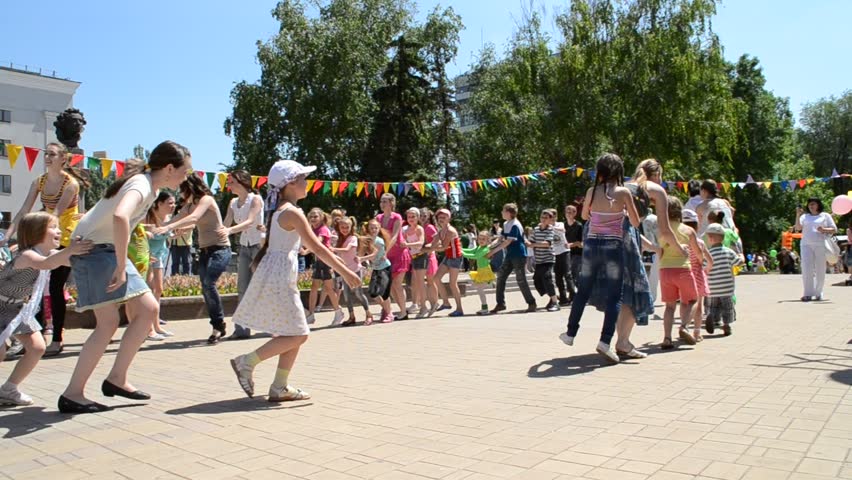 DONETSK, UKRAINE - MAY 29: Children dance in a circle with  parents in celebration of Children's Day, May 29, 2011 in Donetsk, Ukraine. First proclaimed by the United Nations General Assembly in 1954, Children's Day is observed around the world. 