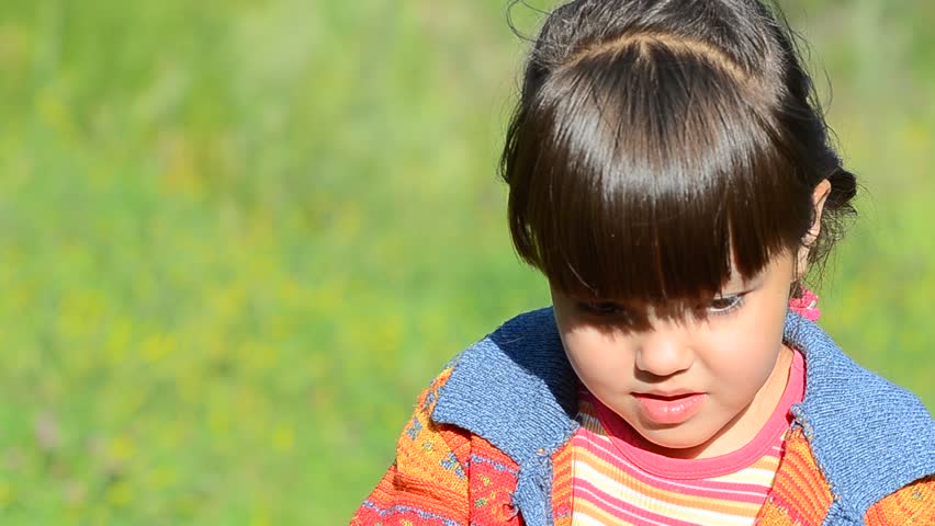 Little girl blows soapbubbles