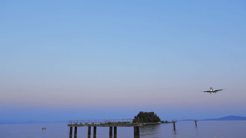 CORFU, GREECE - JULY 3: Landing of Thomson airplane in Corfu airport at sunset. As of July 2011, Thomson Airways is the UK's first airline to launch fry-powered planes. 