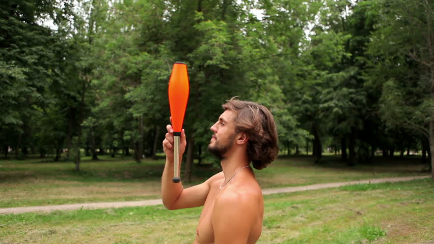 guy tries to balance juggling pin on his chin