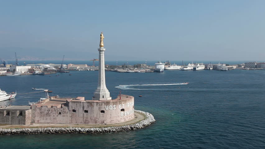 Messina Sicily Italy harbor memorial from ship departing harbor. Italian Navy and Coast Guard boats in port. Stele of Madonna with Vos et Ipsam civitatem benedicimus or I bless you and your city.
