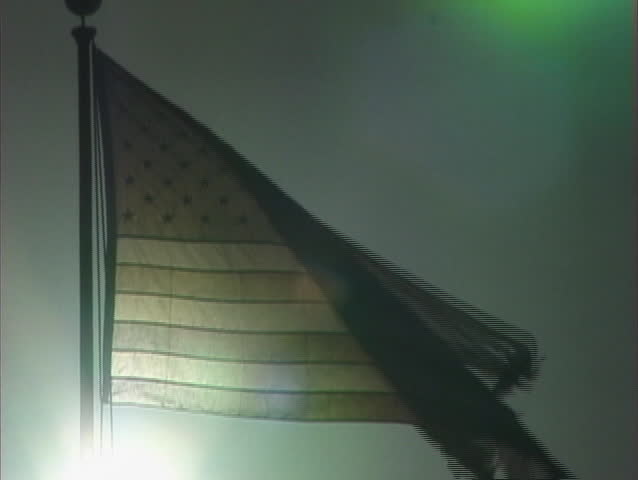 A tattered  American flag on a gray background