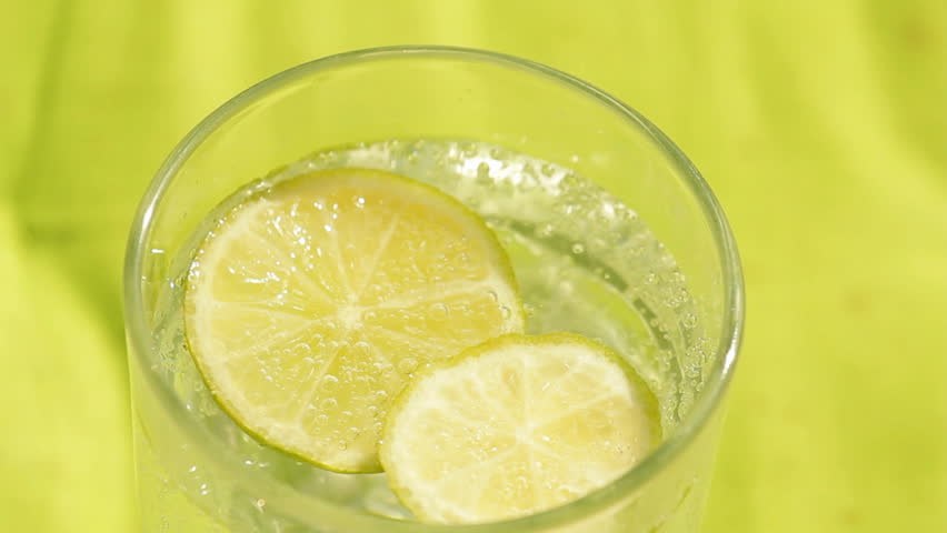 Glass of sparkling water and lemon refreshment background