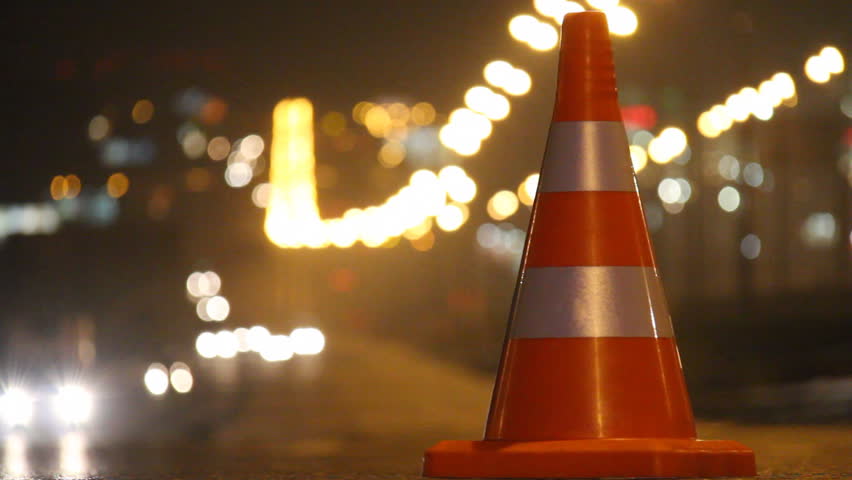 traffic cones exhibited in the line of the roadway and their cars go round