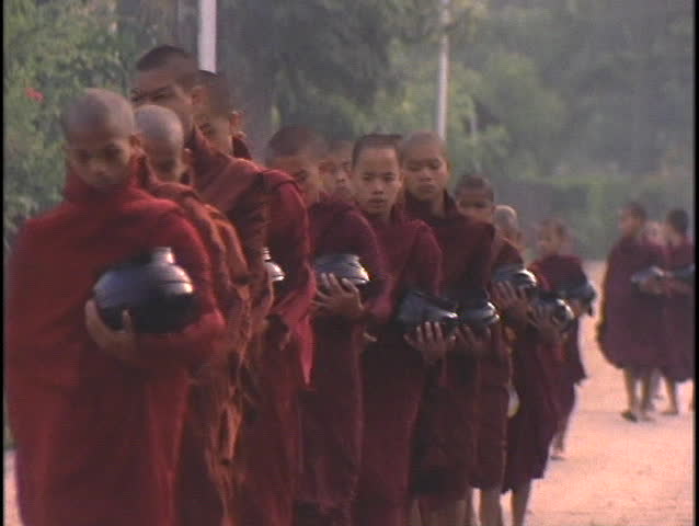 BURMA - CIRCA 2010: Buddhist monks collect alms in the morning circa 2010 in Burma.