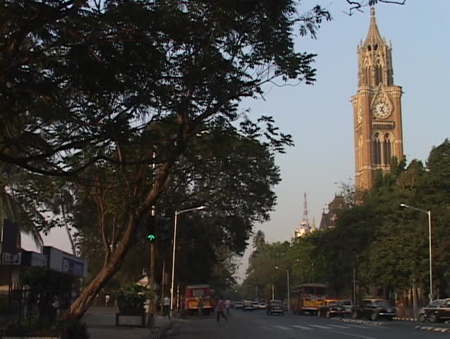 A double-decker bus drives on a street in Bombay.