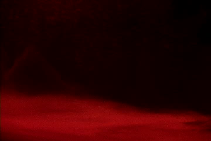 floating black ink mixing with red liquid