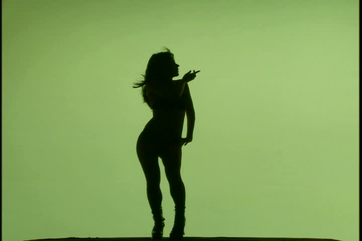 A woman's silhouette dancing against green background