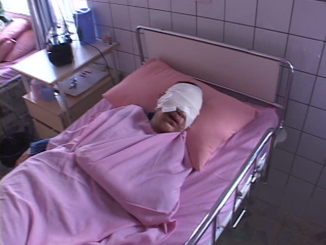 BAGHDAD, IRAQ - CIRCA 2003: An Iraqi man who has been severely injured in the Iraq War lies in a hospital bed in Iraq circa 2003.