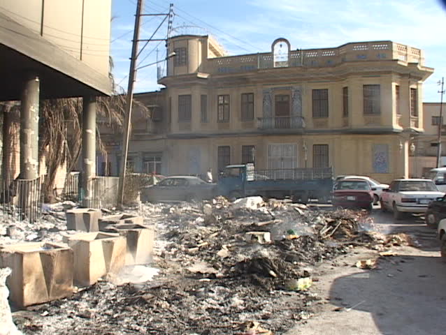 Rubble from a blown up building smolders after a car bombing in Baghdad, Iraq.