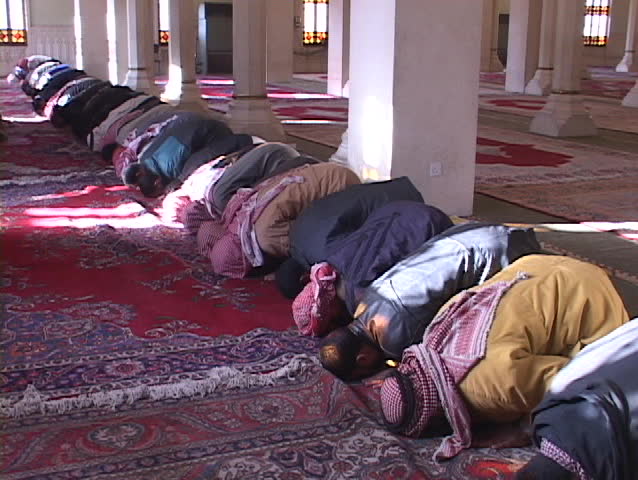 BAGHDAD - CIRCA 2003: Muslims pray in a mosque of war-torn circa 2003 in Baghdad, Iraq.