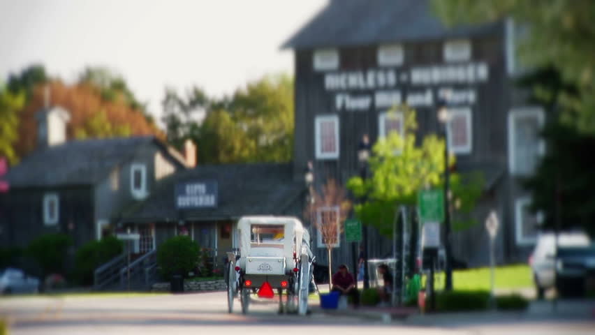 Horse carriage in small town with hazard lights on