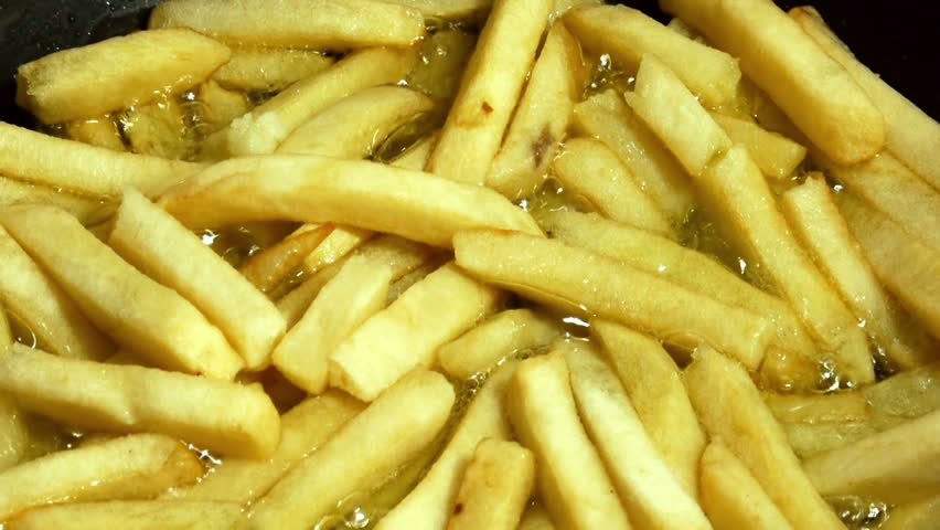 Stirring French French Fries With Spatula 